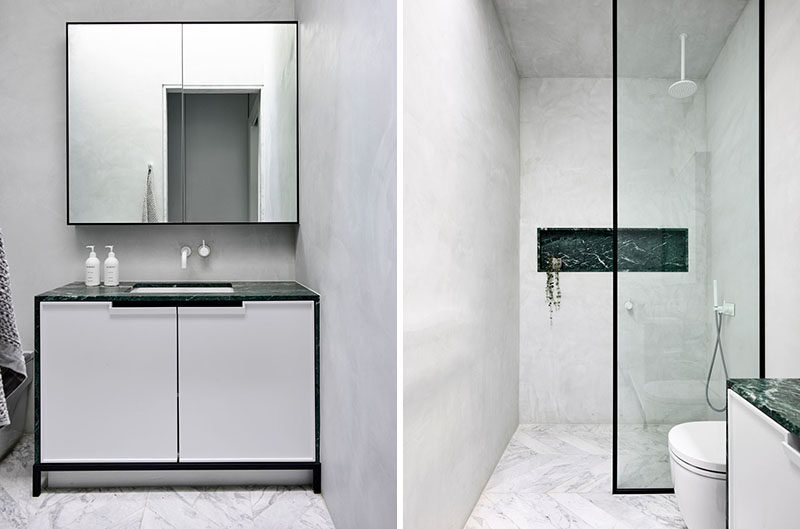 In this modern master bathroom, a simple black framed shower screen separates the shower with a built-in shelf, from the vanity and toilet. #MasterBathroom #BathroomDesign #ModernBathroom