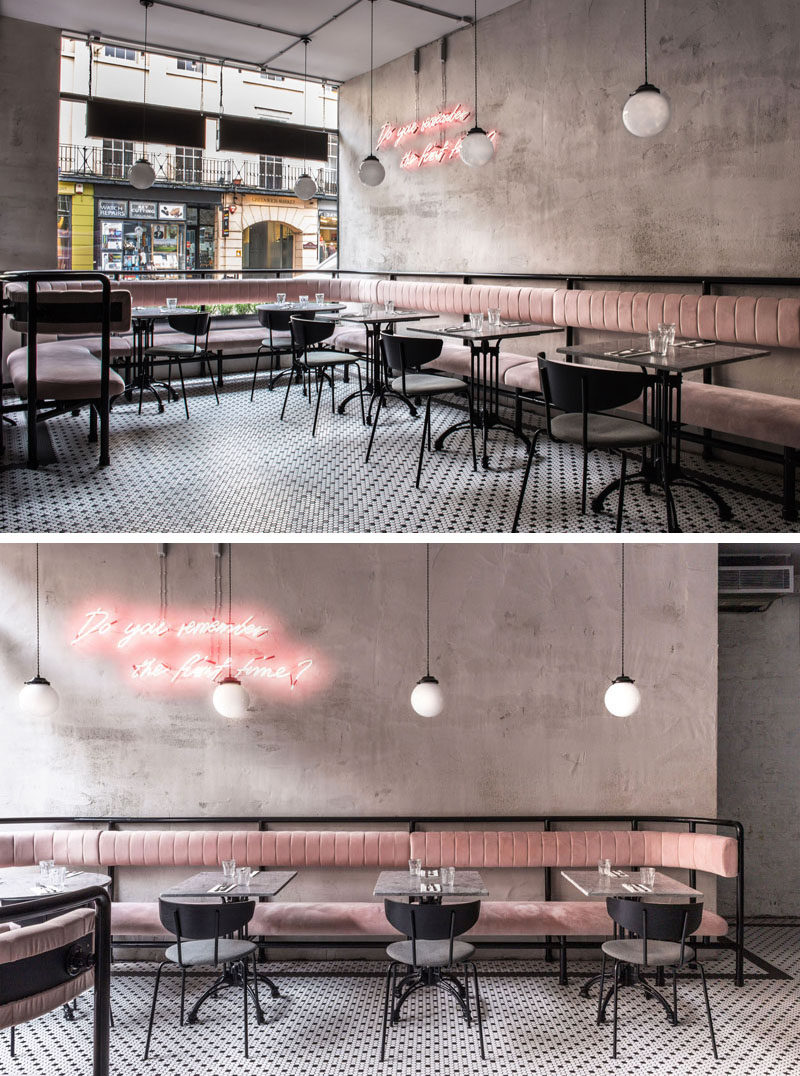 Pale-pink banquettes wrap around the front of this modern restaurant providing lounge seating for bar and restaurant guests, while signature pink neon signage, honed marble tabletops, and black-and-white mosaic flooring, all help to create a fun and welcoming environment. #RestaurantDesign #BanquetteSeating