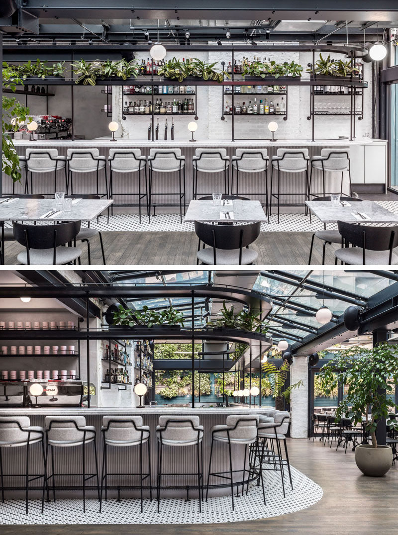 This modern restaurant features a variety of seating, including a bar seating, a communal table, dining tables and banquettes. #RestaurantBar #RestaurantDesign