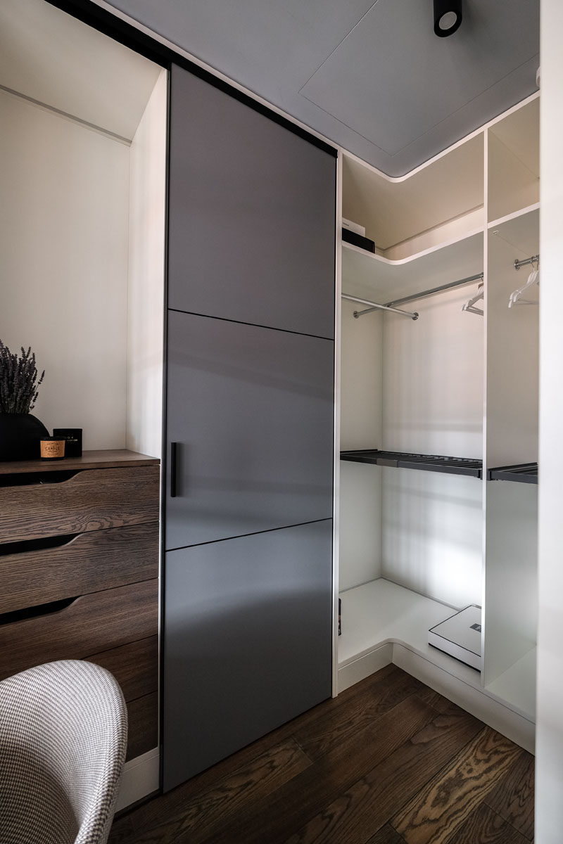 This modern closet has floor-to-ceiling cabinets and a small home office area. #Closet #Shelving