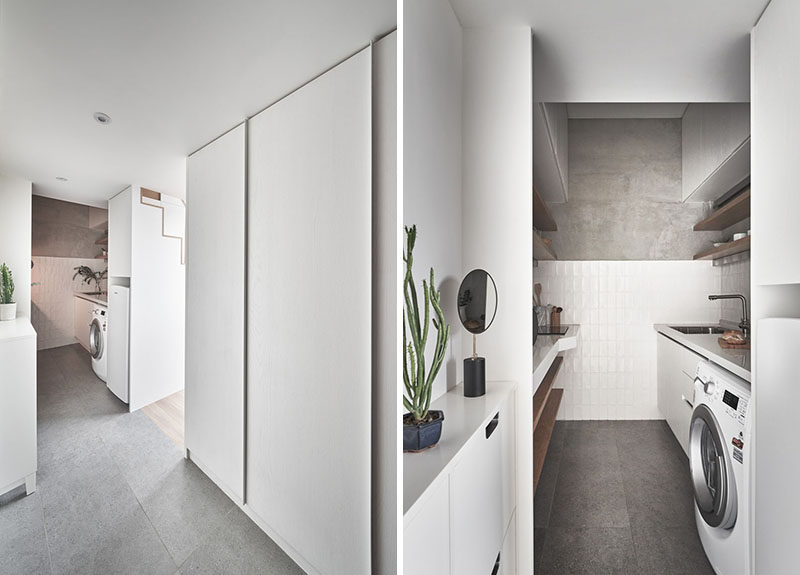 Stepping inside this small and modern apartment, there's an entryway that looks towards the kitchen, and a hidden closet hidden behind large plain white doors. #TinyLiving #SmallApartment