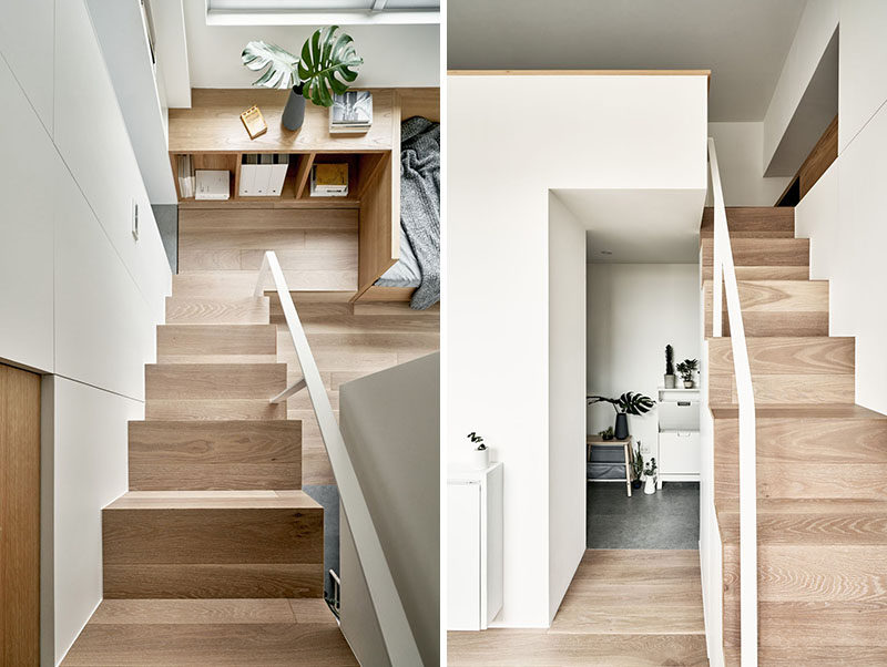 Simple wood stairs with a white handrail lead up to the loft bedroom in this tiny apartment. #Stairs #SmallApartment #TinyLiving