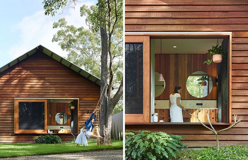 This modern house has a large sliding window that gives the bathroom a view of the backyard. #Window