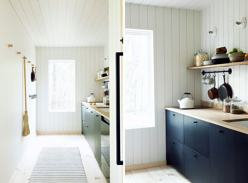 This simplistic and modern kitchen features bleached Eastern Pine floors and walls clad in white painted lap paneling. #KitchenDesign #ModernKitchen #SimpleKitchen