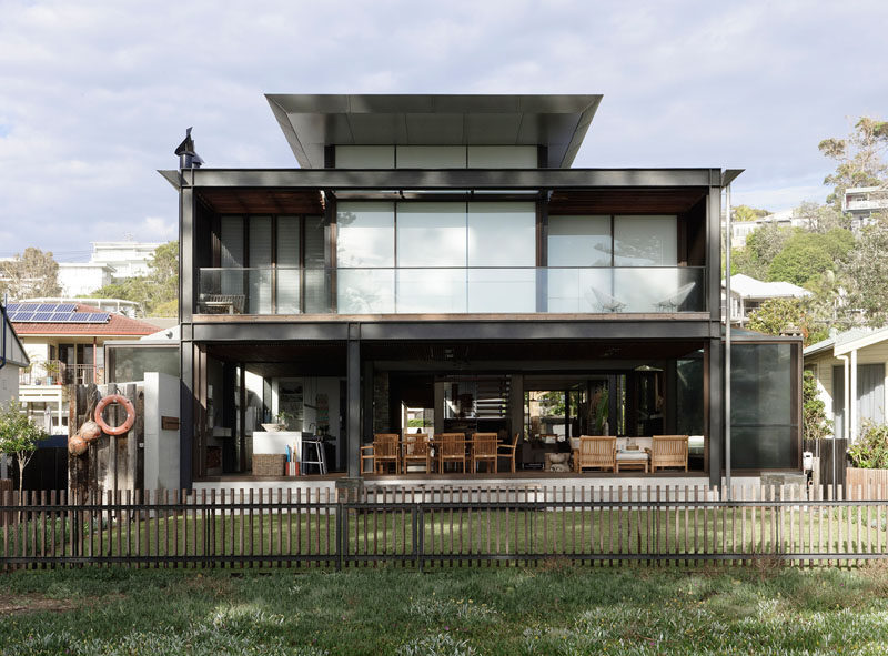 At the rear of this modern house, the verandah, which is enclosable in winter and completely open in summer, provides easy access to the backyard and the beach. #ModernHouse #Verandah #Architecture