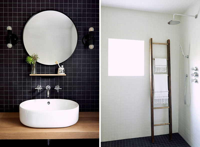 In this modern bathroom , square black tiles contrast the white walls, while a wood vanity and ladder by the shower adds natural touches. #Bathroom #ModernBathroom #MinimalistBathroom