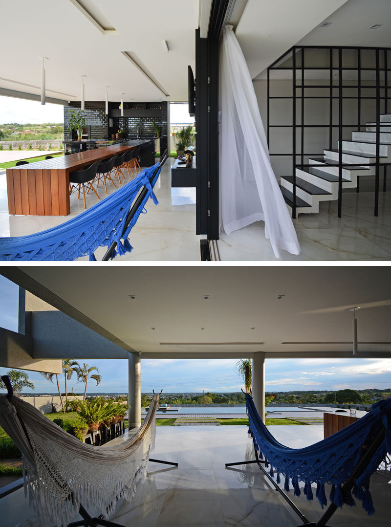 This modern house has a pair of freestanding hammocks, that provide a place to relax and enjoy the breeze and pool views. #Hammocks #ModernHouse