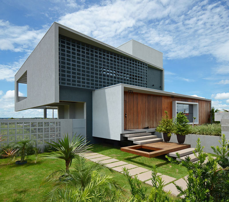 Giordano Rogoski Architects has designed a modern house in Rolim de Moura, Brazil, that's located on a lot with a slope of more than 32 feet (10m) between the front and the back. #ModernHouse #ModernArchitecture #HouseDesign