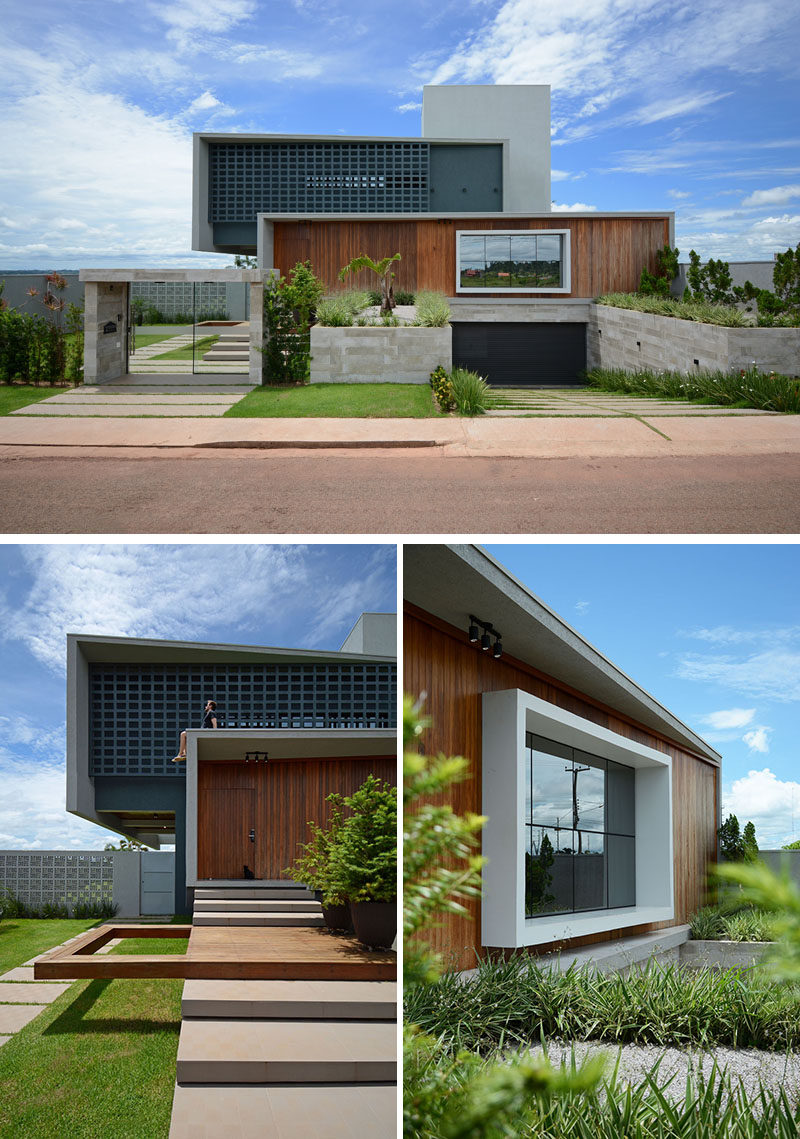 At the front of this modern house, the garage has been sunken down under the house, while the landscaping helps to guide visitors to the front door. #ModernHouse #SunkenGarage #Landscaping