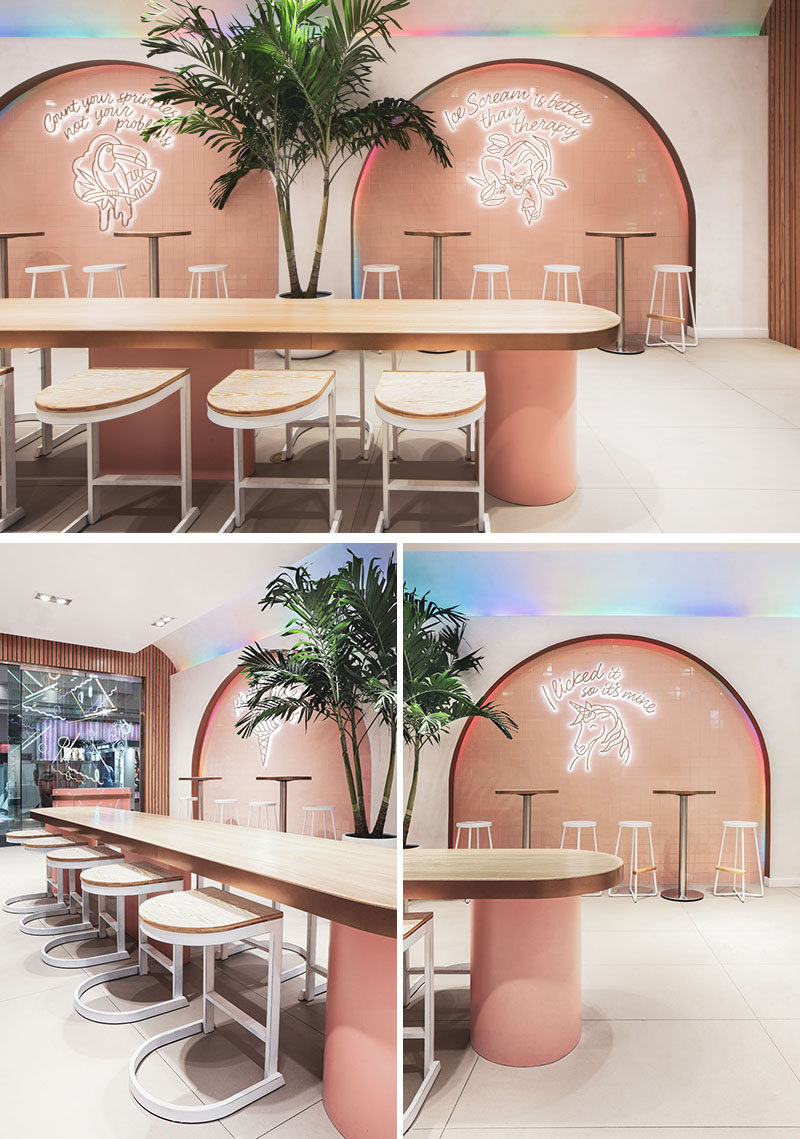 This modern ice cream parlor features four main arches that are accented by multicolored led lighting slowly alternate hues, creating perpetual movement and framing the neon signs. #IceCreamParlor #Arches #RetailDesign #InteriorDesign