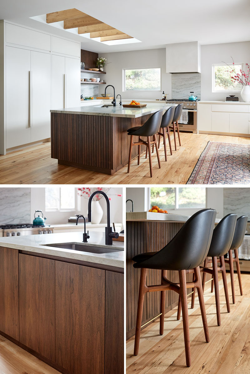 This modern kitchen utilizes sleek, bright cabinetry, and various wood tones to keep the space grounded and warm. #ModernKitchen #KitchenDesign #WoodKitchenIsland