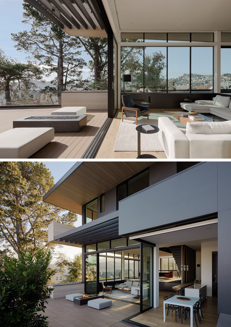 A wall of sliding doors opens this modern living room and smaller dining area to the deck and backyard. #ModernHouse #Deck #SlidingGlassWalls