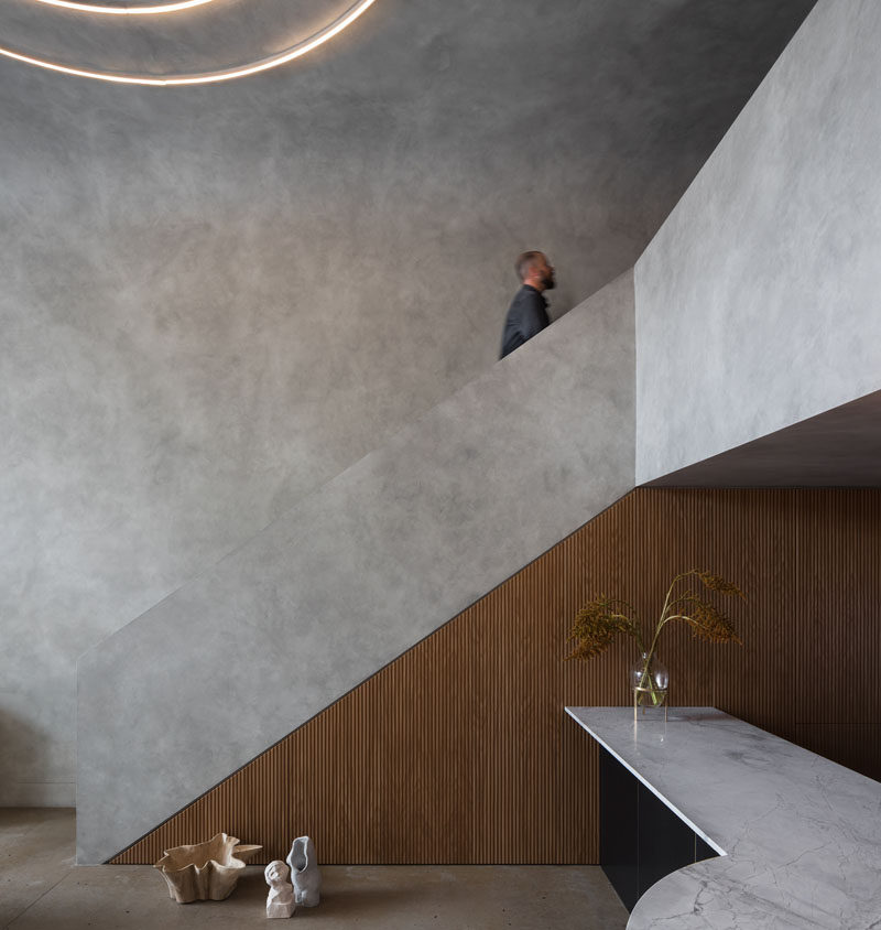 This minimalist loft apartment uses wood accents to add a sense of warmth to the grey interior. #ModernApartment #LoftApartment