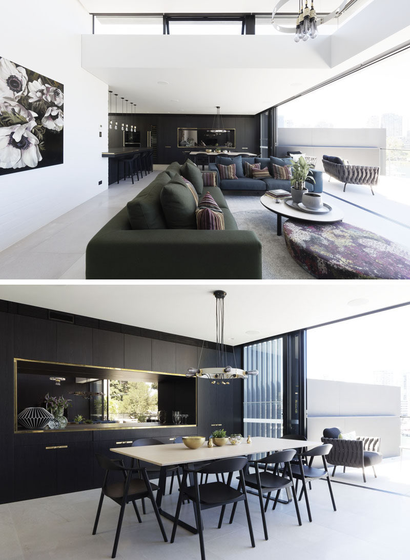 The social area of this modern house is open plan, with the living room, dining area, and kitchen all enjoying the natural light from the balcony. #LivingRoom #ModernDiningRoom