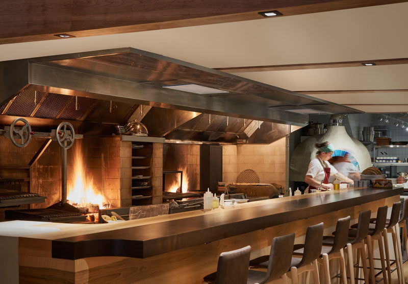 This modern restaurant's open galley kitchen is a 24-foot-long, open-flame grill that runs the length of the space, #ModernRestaurant #RestaurantDesign #RestaurantKitchen