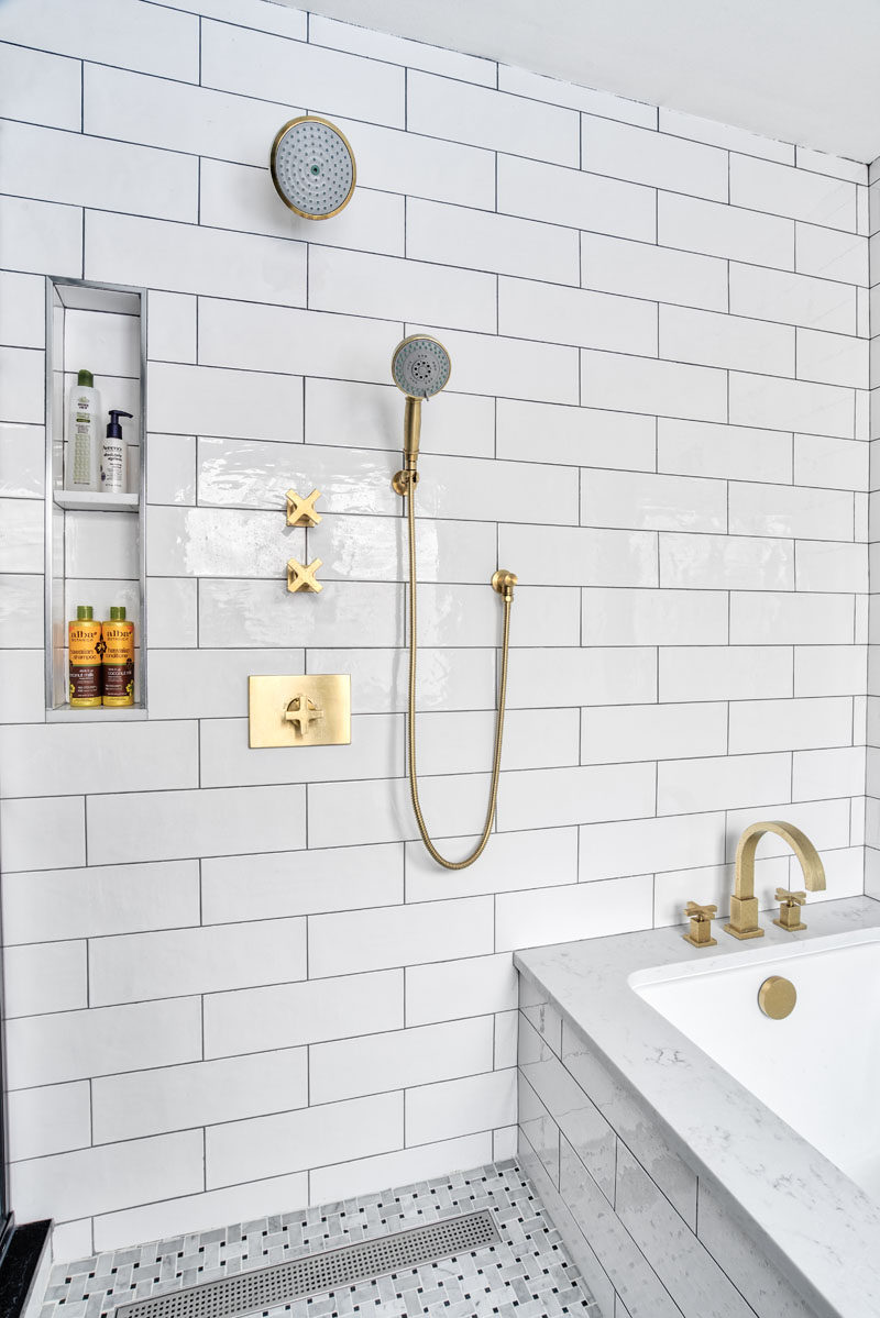 In this modern bathroom, a small nook for storing bathroom items was built-in next to the shower heads to keep them tucked away and out of sight from the rest of the bathroom. #Shower #BuiltInShelving #ModernBathroom #BathroomDesign