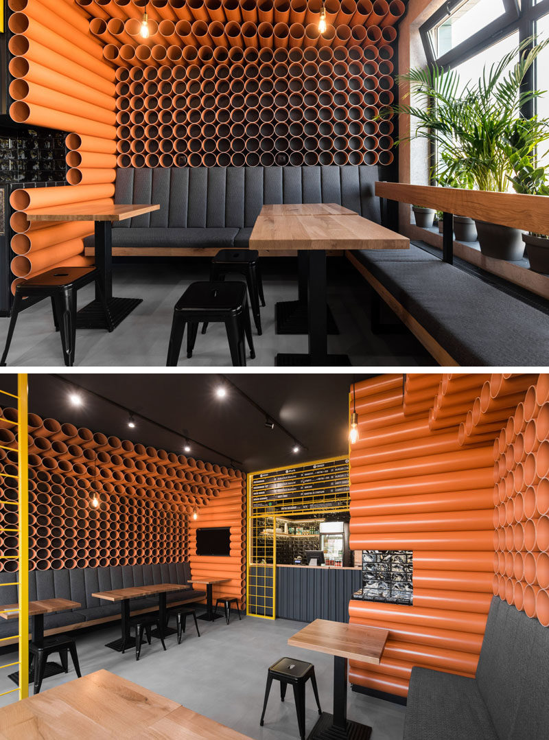 Architecture and interior design firm mode:lina, has recently completed ChiChi 4U, a modern burger restaurant in Poznan, Poland, whose interior is filled with materials that came straight from a building supplies warehouse, like orange PVC pipes and corrugated metal. #RestaurantInterior #BurgerRestaurant #InteriorDesign #ModernRestaurant