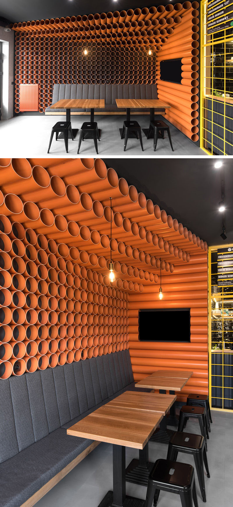 This modern restaurant features almost 300 bright orange PVC pipes that cover the walls and ceilings, while upholstered seating and tables run along the walls, create a comfortable place to sit and eat. #RestaurantDesign #ModernRestaurant #PVCpipes