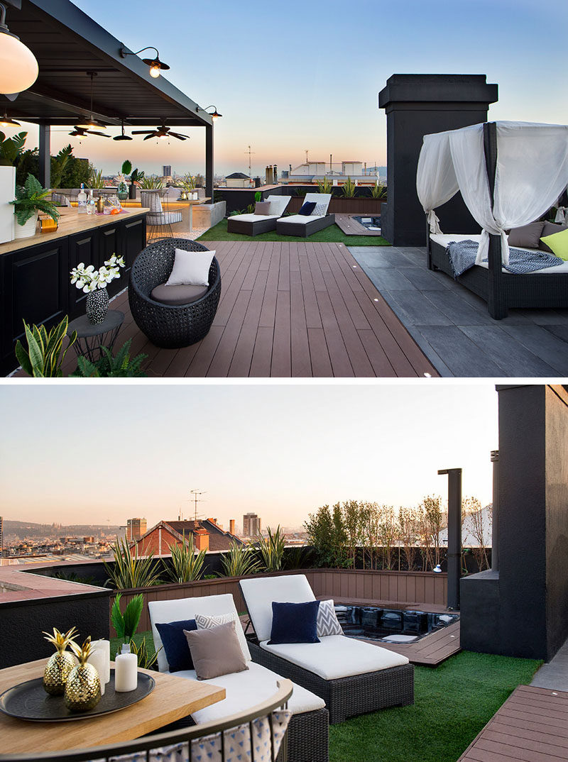 This modern rooftop terrace has a variety of seating areas, a sunken hot tub with an outdoor shower, and a covered kitchen and dining area. #RooftopTerrace #RooftopDeck #SunkenHotTub