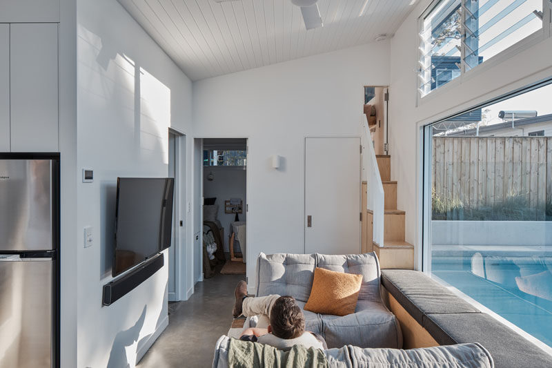 This small house includes a kitchen, living room with a built-in window seat overlooking the pool, 2 bedrooms (sleeping 4), a play space, and a bathroom. #SmallHouse #TinyLiving #MicroLiving