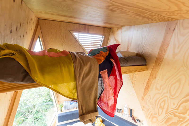 This tiny cabin has a sleeping loft perched between the angled walls. #SleepingLoft #TinyCabin