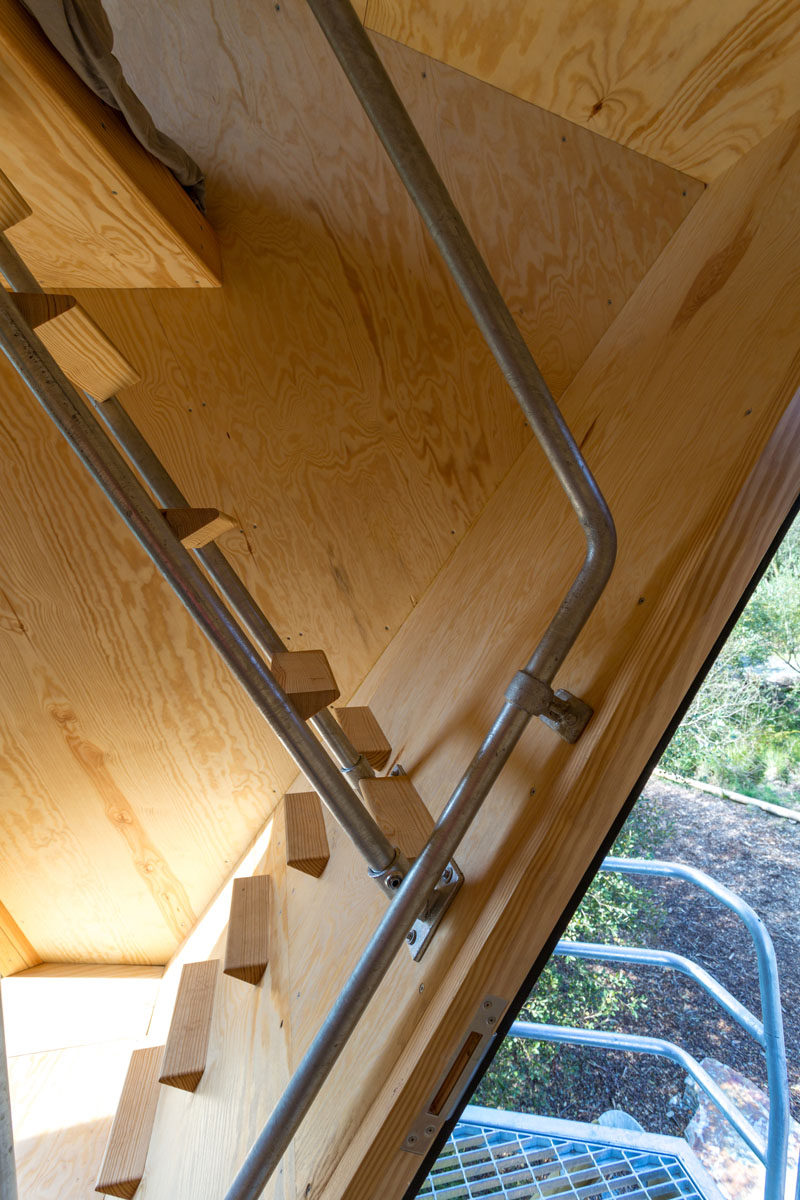 Simple stairs with tiny wood treads have galvanised steel railings that lead up to a sleeping loft in this small cabin. #Stairs