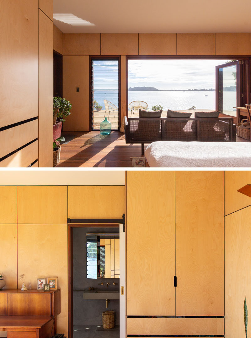 The bedroom of this modern beach house opens onto a sandstone terrace constructed from stone from the site. #Bedroom #Wood