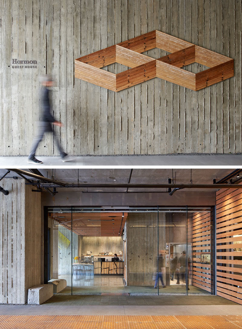 A textured concrete wall that leads to the lobby of this modern hotel, features an wood art piece by Andy Vogt, which he made from salvaged hardwood lath boards arranged to create two-dimensional Escher-like “drawings” that appear three-dimensional. #HotelDesign #ConcreteWall #WoodWallArt