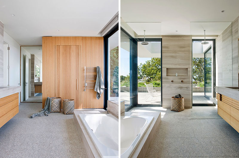 In this master bathroom, a marble vanity and white walls have been combined with oak paneling to create a contemporary appearance. #ModernBathroom #BathroomDesign