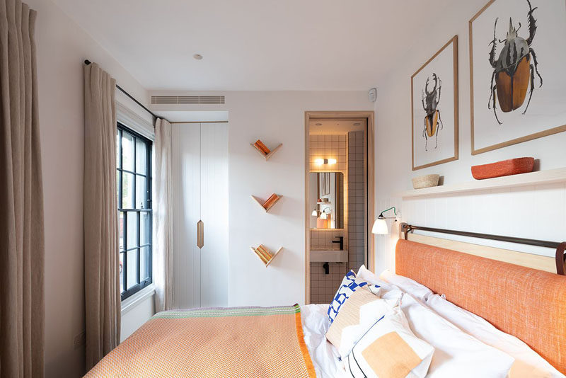 In this modern bedroom, orange has been used to add a colorful touch to the space. #ModernBedroom #BedroomDesign