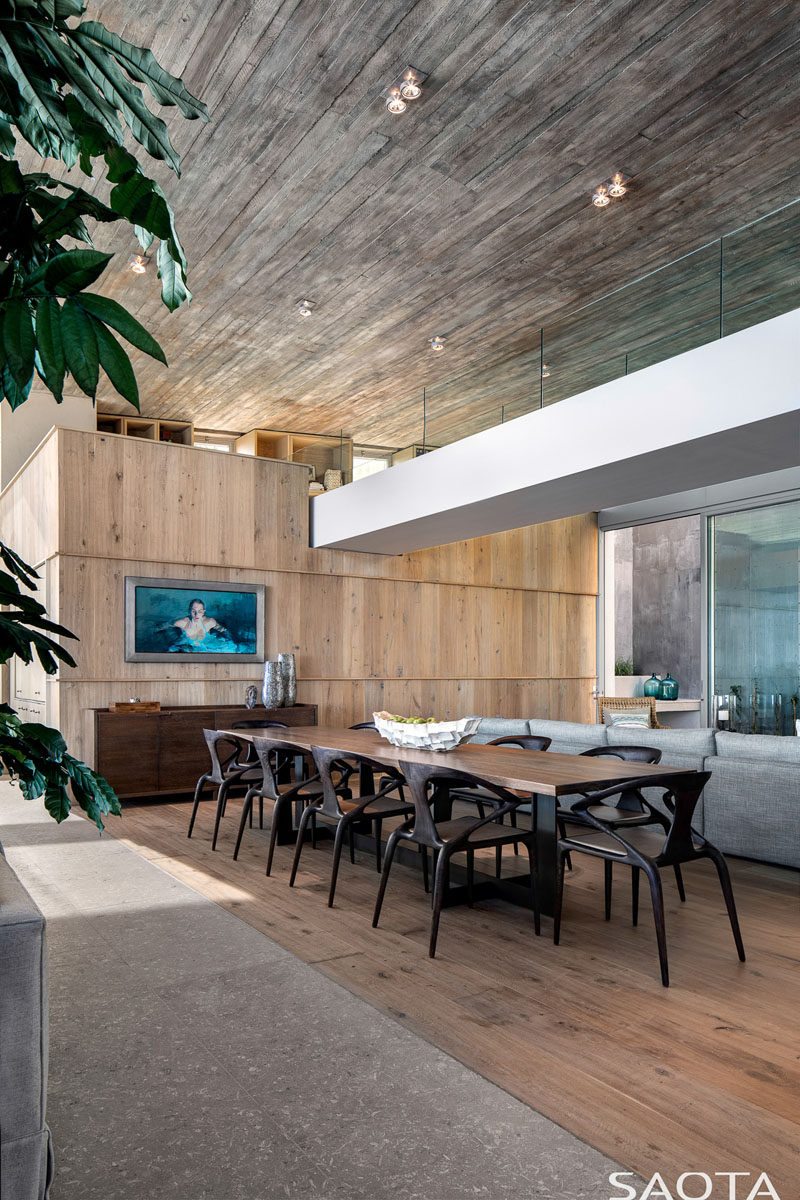 This large, modern dining area showcases the concrete ceiling and rough-sawn planks. #DiningRoom #ModernDining