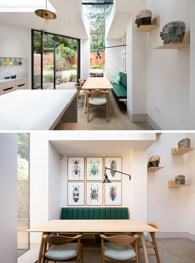 This rear house extension has a skylight that wraps from the ceiling down to a window, while green and wood banquette seating at the dining helps to provide a relaxed atmosphere. #DiningRoom #HouseExtension #Skylight