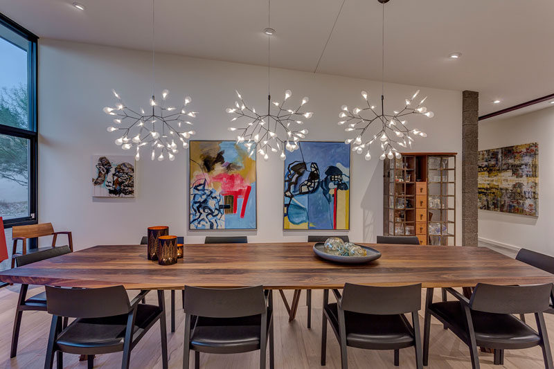 A custom Danish dining room table and elegant light fixtures help define this modern formal dining room. #DiningRoom #ModernDiningRoom