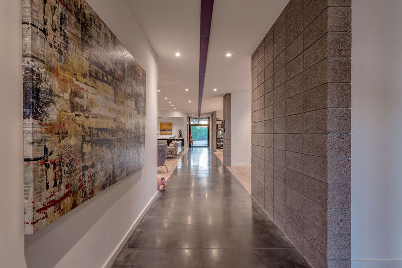 Art is featured all through this modern house and is often emphasized in the hallways. #Hallway #InteriorDesign