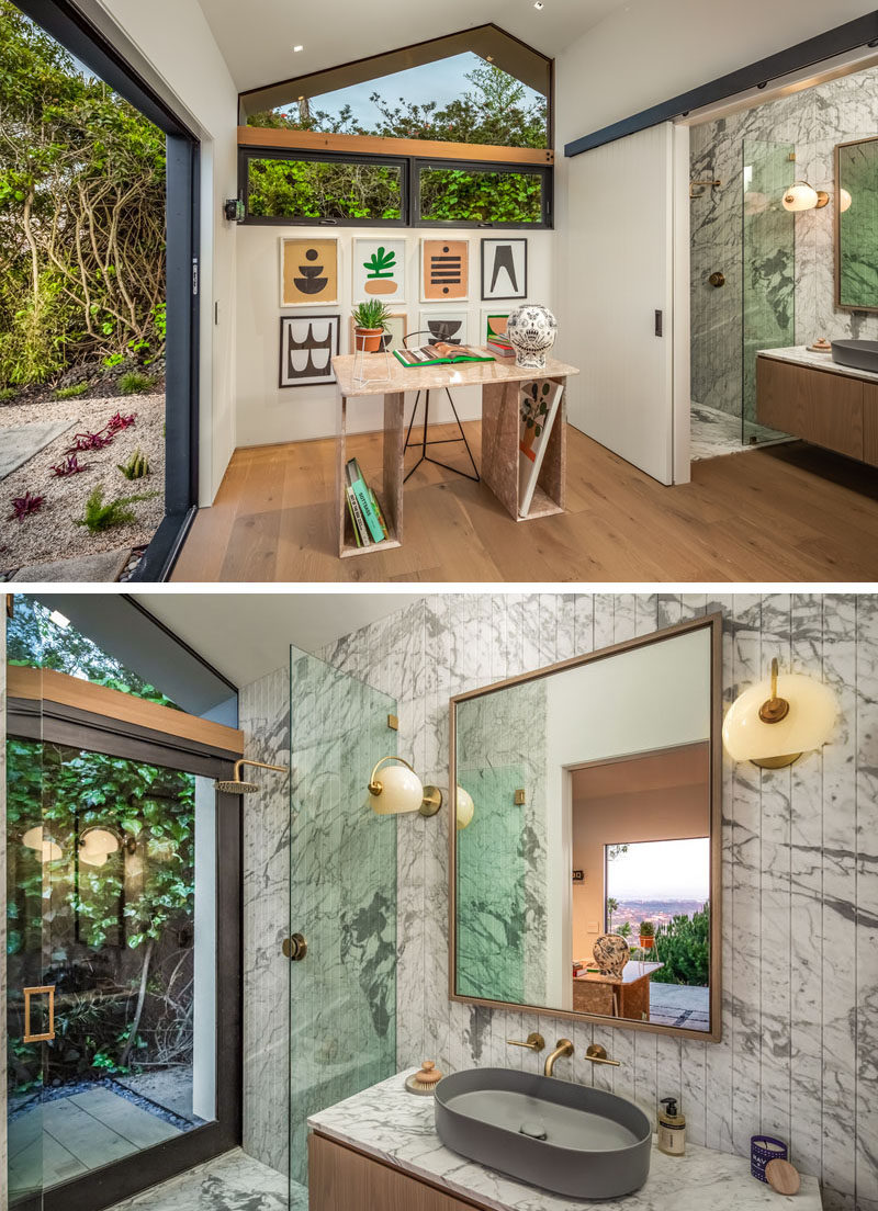 This modern house has a guest suite, currently being used as a home office. Behind a suspended sliding door is an ensuite bathroom, with a walk-in shower and a floating wood vanity. #GuestSuite #HomeOffice #EnsuiteBathroom #ModernBathroom