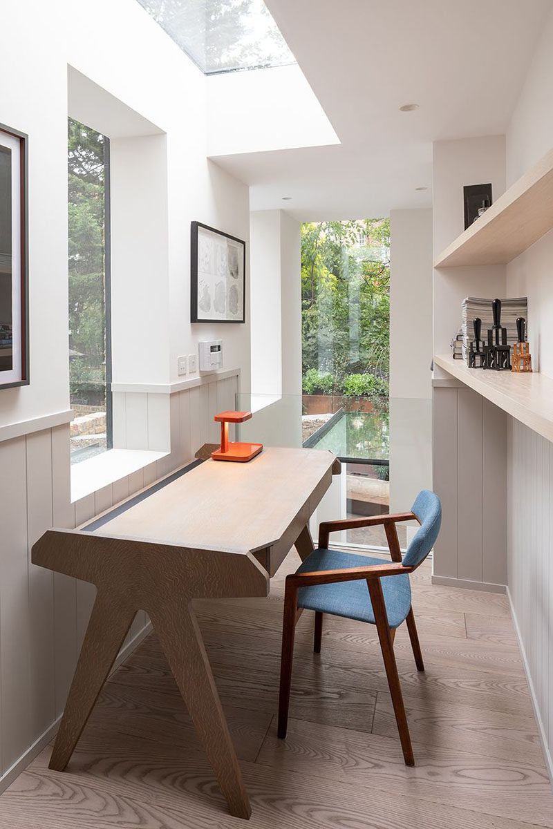 Skylights and windows provide an abundance of light to this modern home office, while light oiled ash flooring adds a natural touch. #HomeOffice #Skylights