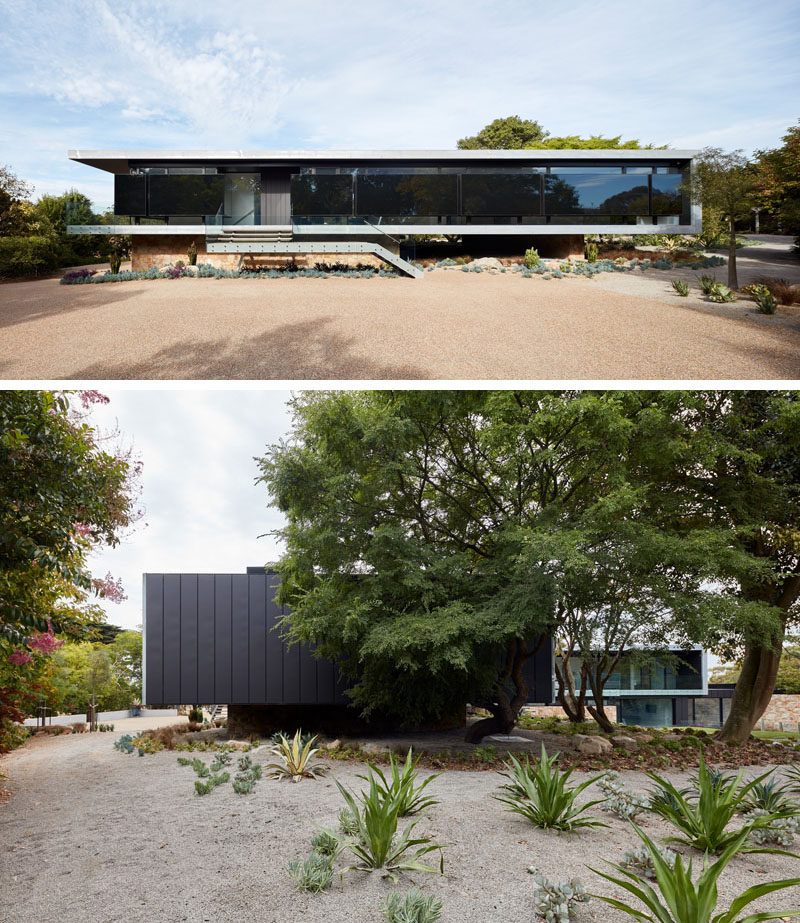 This modern house has walls of windows, however insulated black panels have been added for weather protection, as well as reflecting the silhouette of the established gardens. #ModernHouse #ModernArchitecture