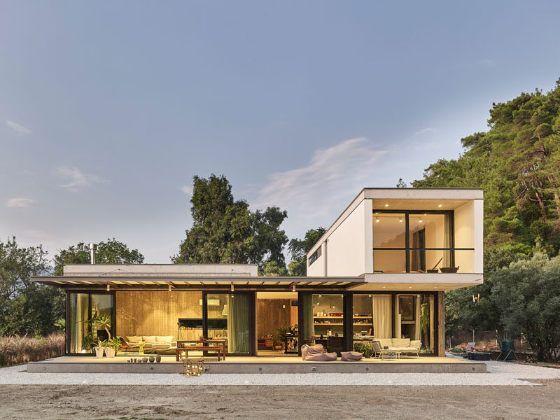 This modern house in Turkey was designed with minimal materials, such as concrete, aluminium-framed glass windows and natural wood. #ModernHouse #ModernArchitecture #HouseDesign