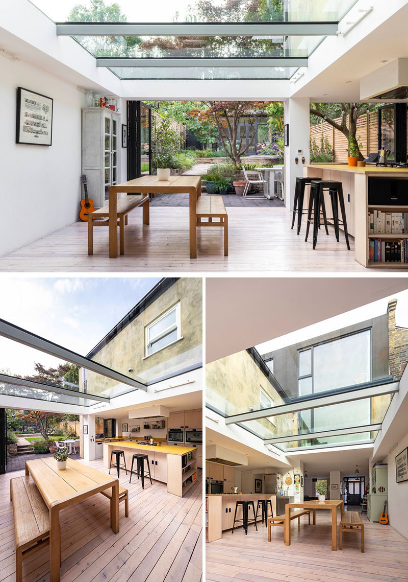 This modern house extension has folding glass doors and a wide slot window in the kitchen, further extending the internal spaces into the garden. #ModernHouseExtension #Skylights #OpenPlanInterior #DiningRoom