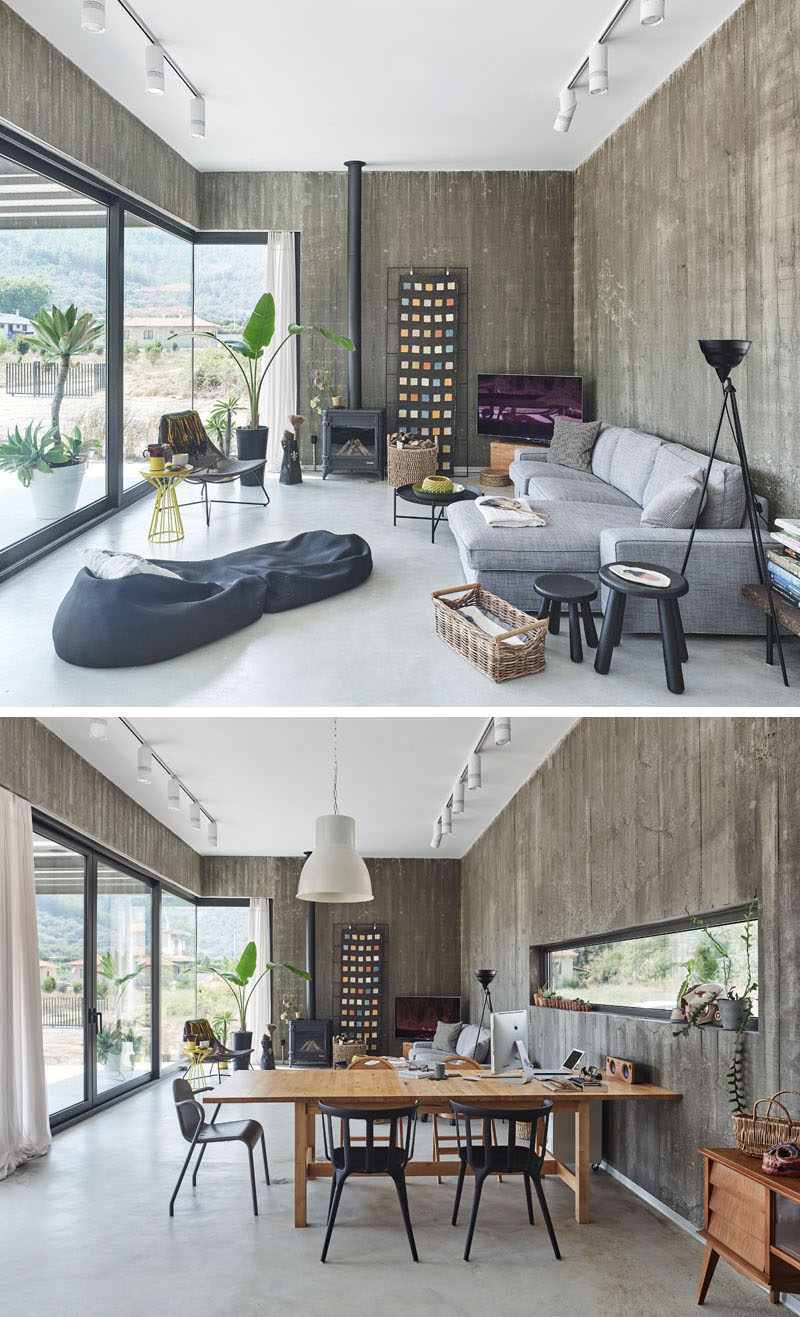 Inside this modern house, exposed concrete walls are softened by the use of comfortable couches, plants, and artwork. #ModernLivingRoom #ModernInteriorDesign