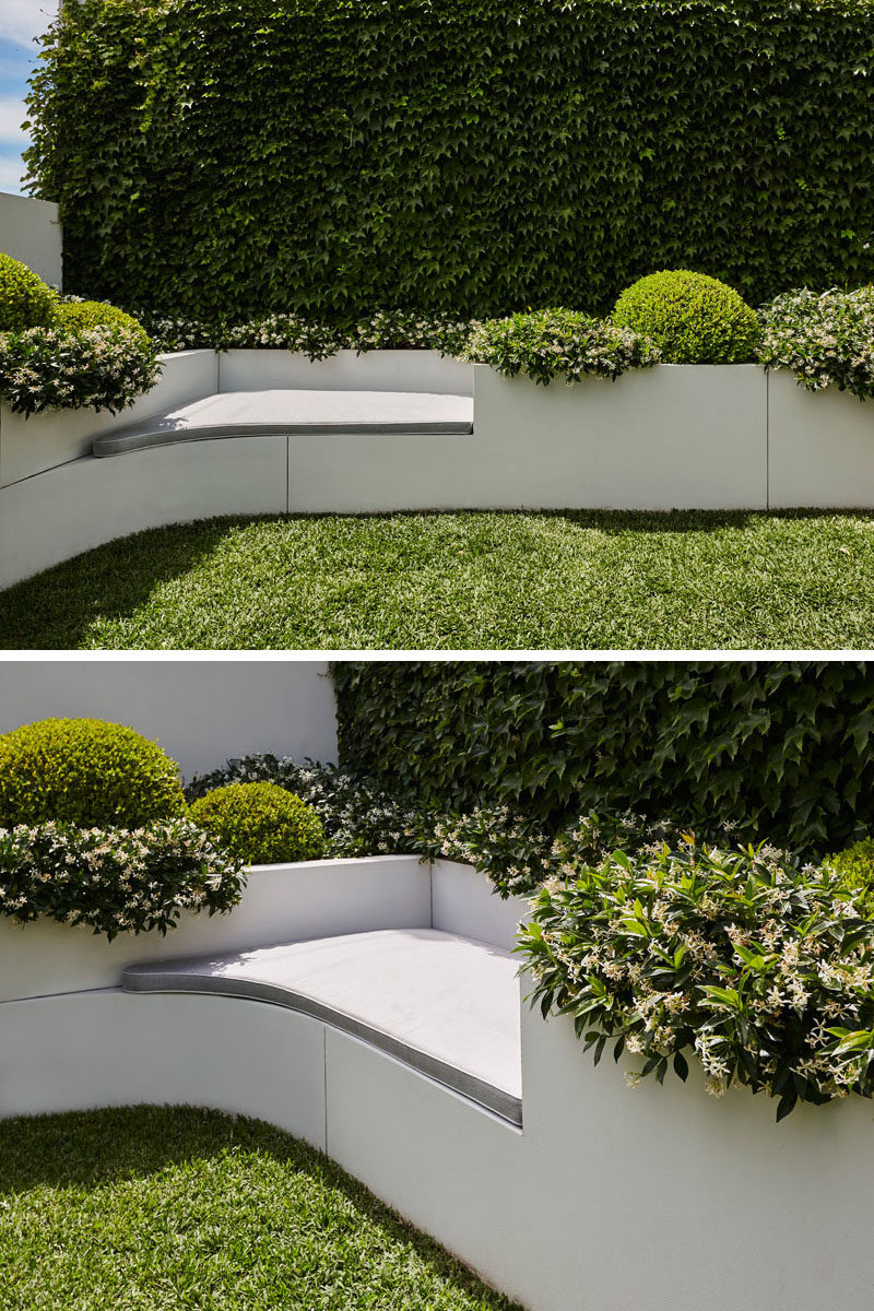 In this modern yard, a built-in seat has been included that provides a place for someone to relax next to the planters. #Landscaping #Backyard #BuiltInSeat #Planters