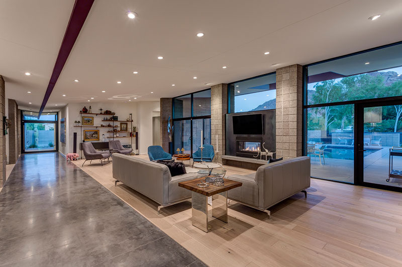 This modern living features a material palette of exposed beams, sandblasted block, concrete, stucco, wood floors, and glass. #LivingRoom #ModernLivingRoom