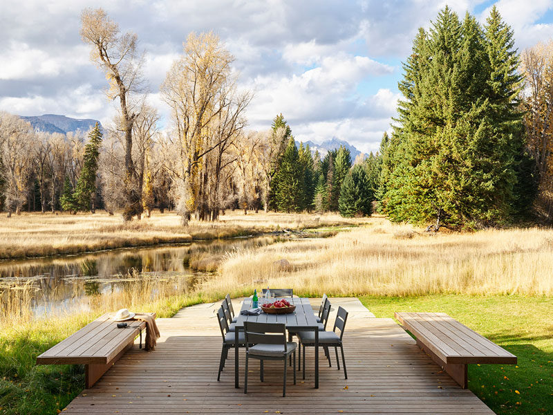 This simple wood deck provides a place for outdoor dining while looking out towards the creek. #Deck #OutdoorDining