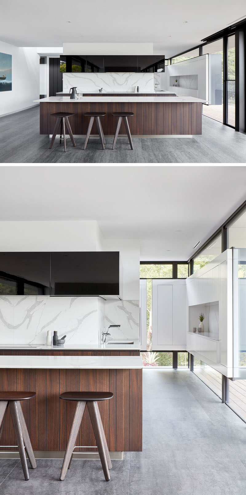 In this modern kitchen, bright white walls are contrasted by black design elements, like cabinetry and window frames, while the wood island adds a touch of warmth to the space. #ModernKitchen #KitchenDesign