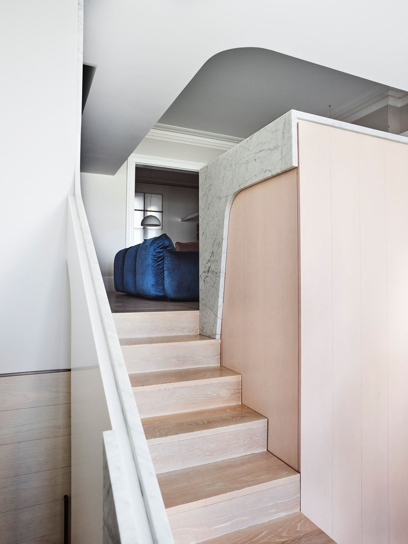 In this house renovation, wood steps lead from the formal living room down to a new, open and airy living space. #WoodStairs