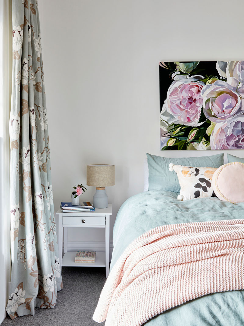 This master bedroom features a soft color palette with pinks and blues. #BedroomIdeas #MasterBedroom