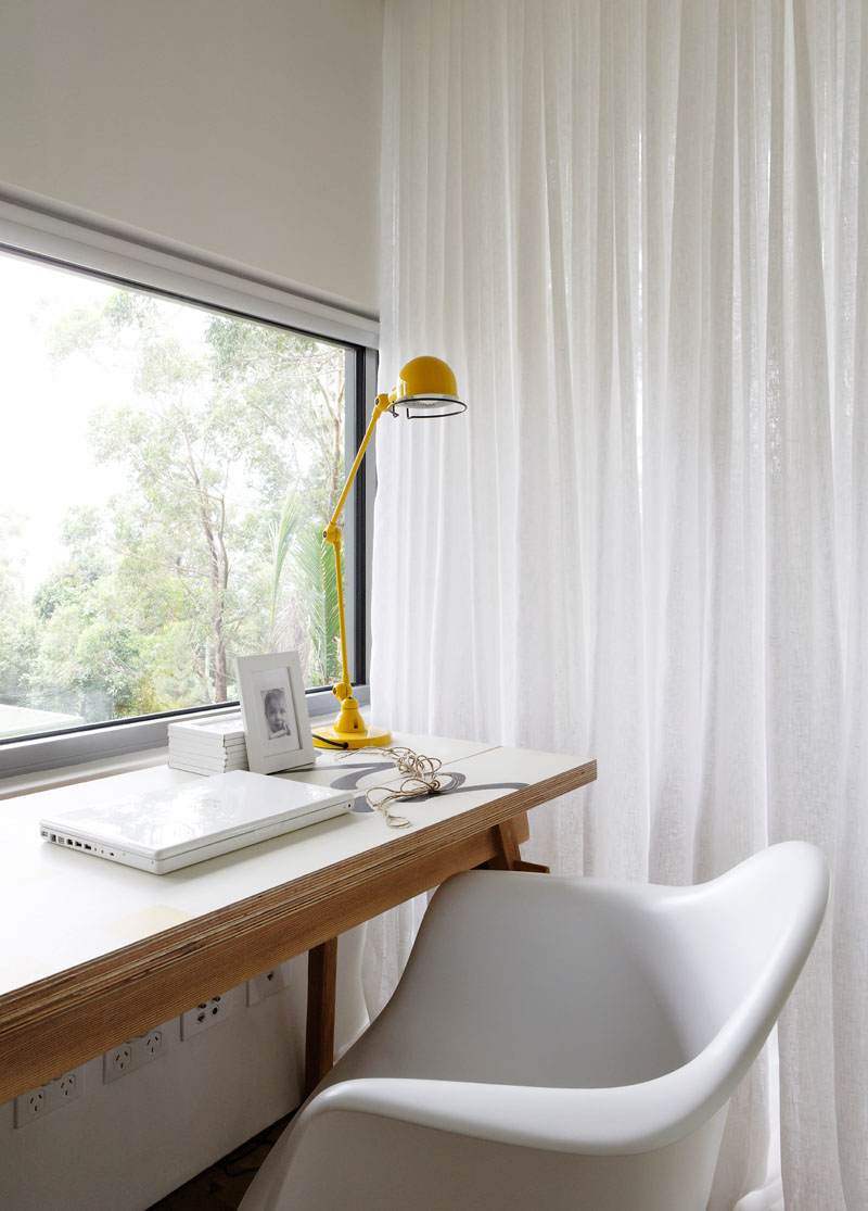 This small office area makes use of the window light to create a bright work environment. #HomeOffice #ModernInterior