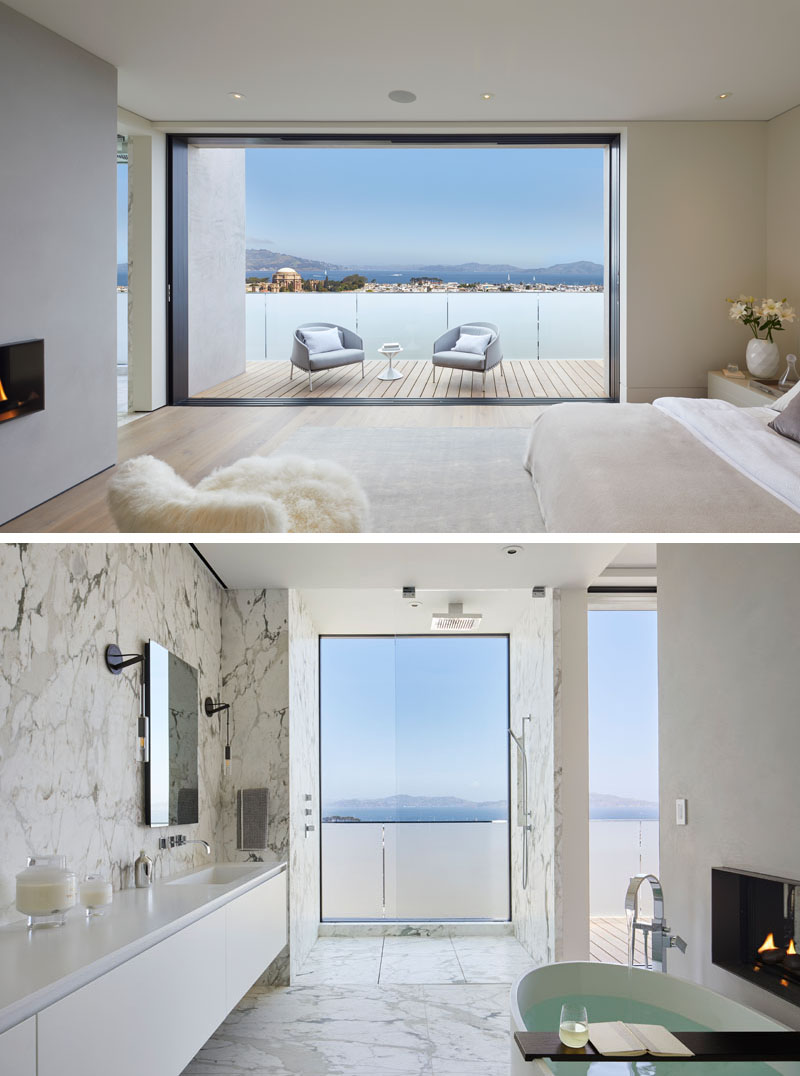 This modern bedroom has sliding doors that open to a balcony with frosted glass, creating privacy for the occupants, while a double-sided fireplace can be enjoyed from both the bedroom and the ensuite bathroom. #ModernBedroom #ModernBathroom #MasterBedroom