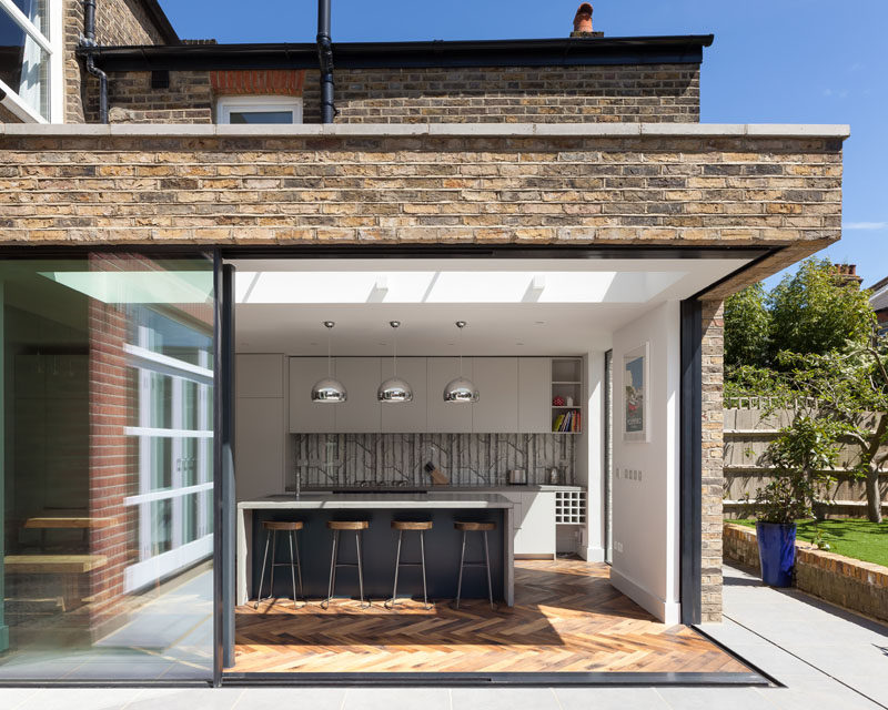 Large sliding glass doors connect this kitchen to the garden. #SlidingGlassDoors #KitchenDesign #KitchenExtension