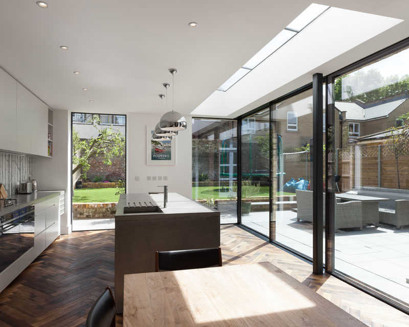 Dissolving the boundary between the outdoors and the indoors in this home, are a set of sliding glass doors framed in powder-coated aluminium. #SlidingGlassDoors